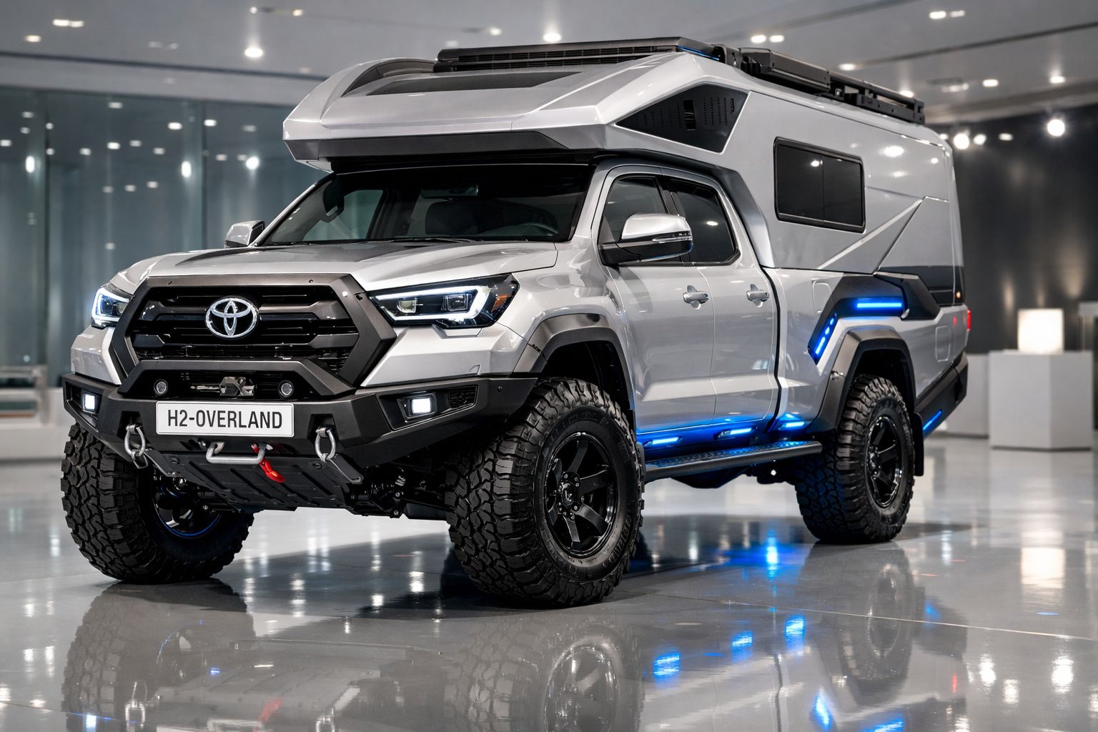 Toyota H2-Overland prata com pneus off-road e iluminação azul em ambiente interno moderno.